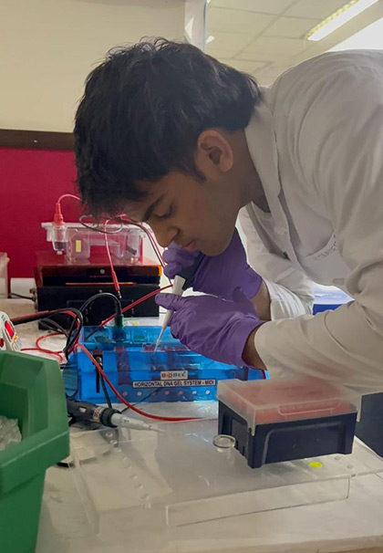 Hridank Goradia examining biological samples during his research at RSI-India 2025