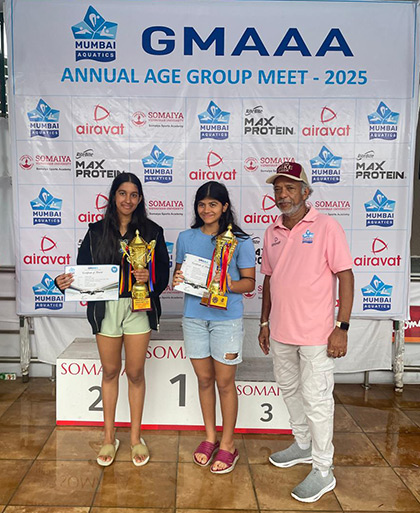 Swimmers with trophies and medals on the podium at the GMAAA Annual Age Group Meet 2025