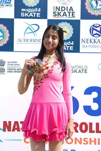 Rhythm Mamania proudly displaying her medals at a national roller skating championship